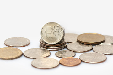 Coins of russian rouble and american dollar in relationship on white background. close-up view
