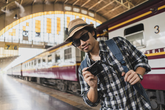 Asian man bag pack tourist with camera in railway station at Thailand.