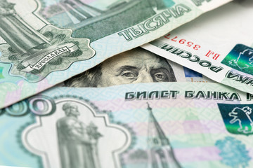 100 dollar bill is hiding under rubles banknote