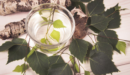 A glass of birch juice on wooden background