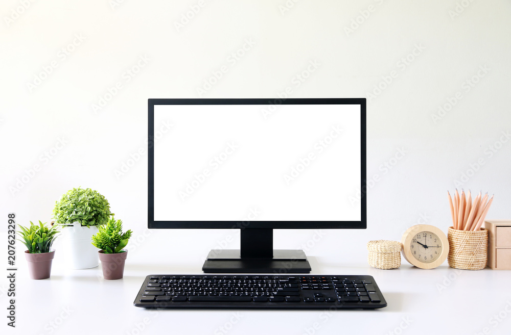 Poster front view blank screen computer with mouse, keyboard,pencils and tree vase in modern office