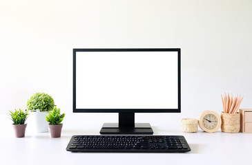 Fototapeta premium front view blank screen Computer with mouse, keyboard,pencils and tree vase in Modern office