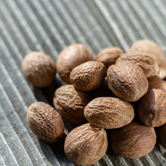 aromatic nutmeg on a gray wooden background