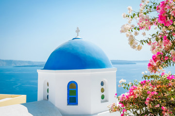 Greek whitewashed church dome with blue roof at Oia Santorini Greece