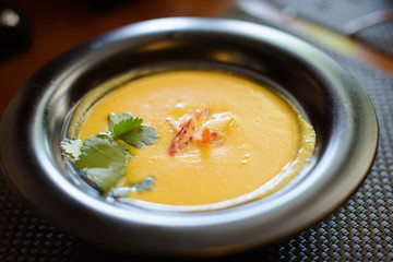 corn soup with crab on black plate