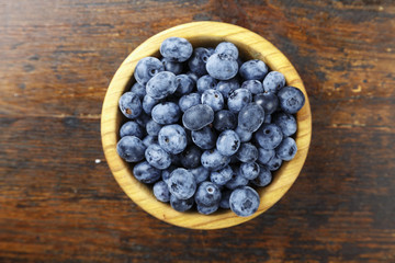 ripe organic bog whortleberry in a wooden plate