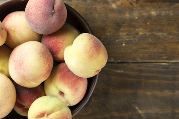 ripe peaches on a wooden background