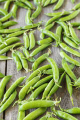 Green peas on wooden table. Organic food. Space for text