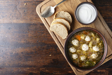 soup with meatballs on a wooden background