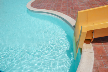 Stylishly interesting water slide in the pool near the sea on nature background