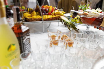 Barman pouring whiskey in crystal glasses