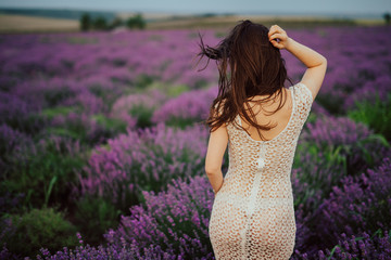 Young sexy girl in white dress in a field with lavender
