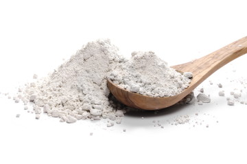 Pile of wheat flour in wooden spoon isolated on white background