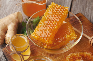 Golden honeycombs and honey jar, closeup