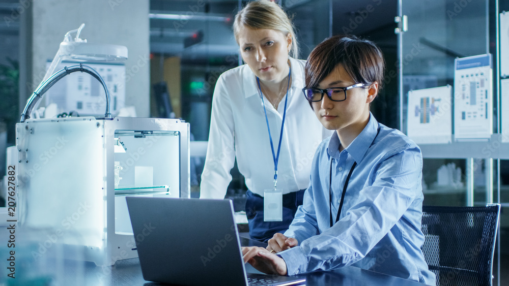 Poster two engineers work with three dimensional printer in laboratory