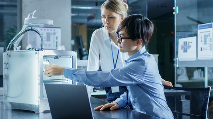 Two Engineers Work with Three Dimensional Printer in Laboratory