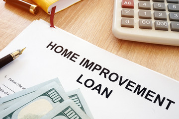 Home Improvement Loan form and money on a desk.