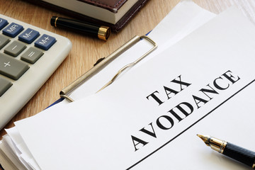 Documents about tax avoidance on a desk.