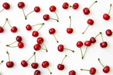 Obraz na płótnie Canvas Cherries on white background isolated in chaotic manner as background