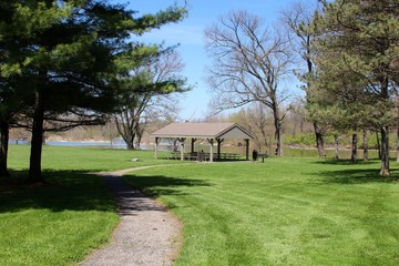 The empty picnic shelter near the river in the park.