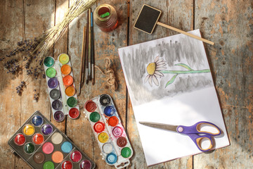 drawing paints camomile (image flower) paints watercolor, pencils, drawing album. Flat Lay. Background