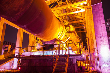 Factory buildings and industrial equipment in the evening