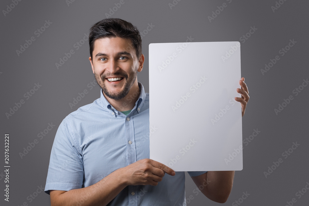 Wall mural youn man holds board