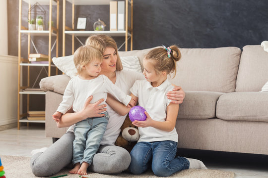 Happy mother playing with her daughters