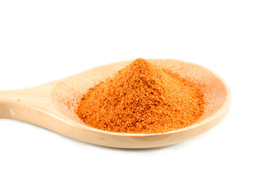 Cayenne pepper on the wooden spoon on a white background.