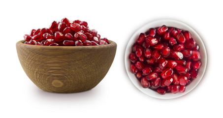 two bowls with pomegranate seeds isolated on white background. Ripe pomegranates close-up. Sweet and juicy garnet with copy space for text.