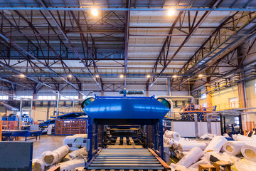 Fiberglass production industry equipment at manufacture background