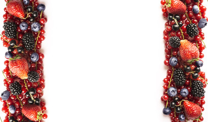 Mix berries on a white background. Ripe red currants, strawberries, blackberries, blueberries, blackcurrants on white background. Top view. 