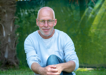 Naklejka na ściany i meble portrait of senior man with glasses, outdoors