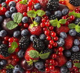 Ripe blackberries, blackberries, strawberries, red currants, peaches and plums. Mix berries and fruits. Top view. Background berries. 