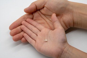 Kid and mother hands holding milk teeth. Childhood healthcare