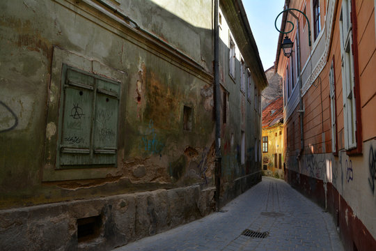 Fototapeta Alecu Russo Street , unique atmosphere and amazing old colorful narrow street in the center of Brasov, beautiful city in Romania.