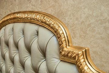 Luxury furniture detail. Leather upholstery of a classic bed. Chesterfield style