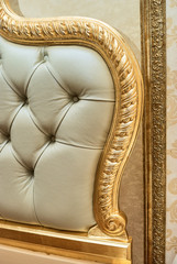 Luxury furniture detail. Leather upholstery of a classic bed. Chesterfield style