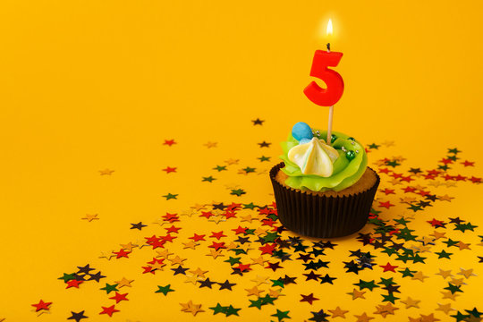 Fifth birthday cupcake with candle and sprinkles
