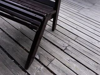 Fototapeta na wymiar Wooden chair on wooden plank floor on a pier