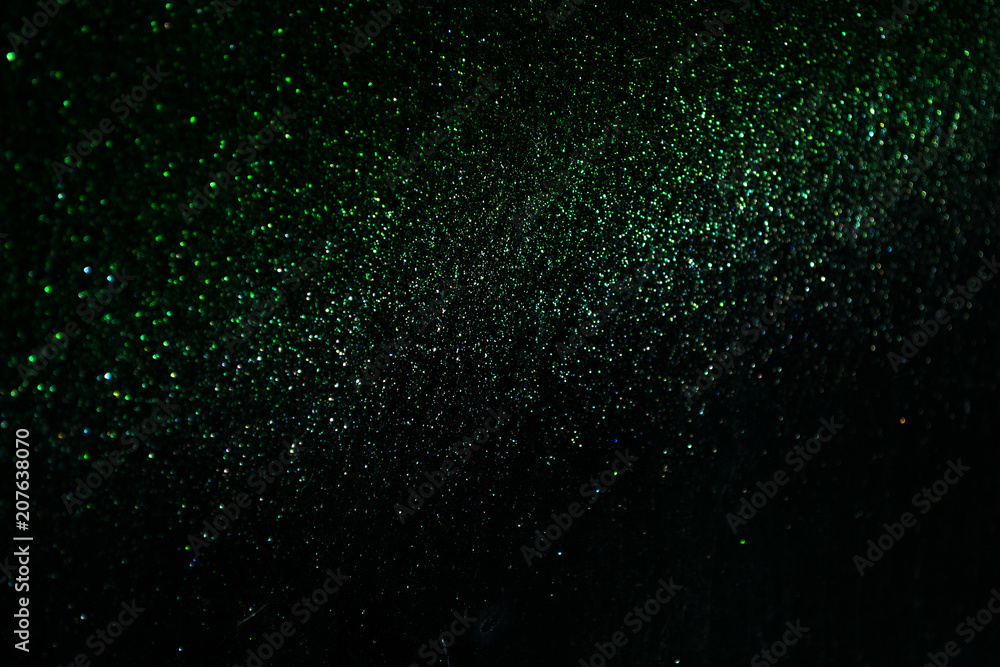 Wall mural green sparkling and shining star points on a black isolated background will create a festive mood