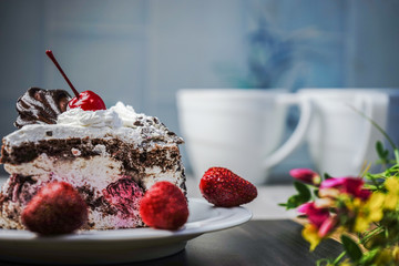 Slice of cake with cherries and strawberries