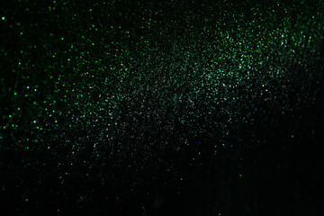 green sparkling and shining star points on a black isolated background will create a festive mood