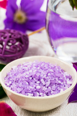Fototapeta premium Purple Lilac and Clematis Salt for Spa and Aromatherapy. Selective focus.