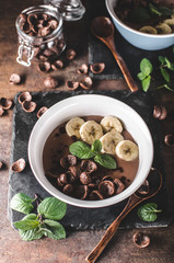 Chocolate pudding, banana and herbs in
