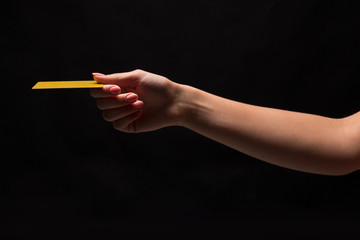 Closeup of female hand holding plastic card