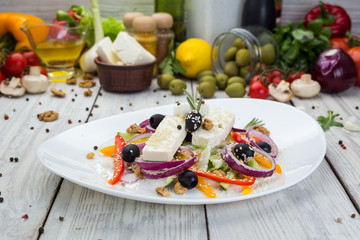 Greek salad with fresh vegetables, feta cheese and black olives