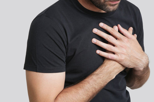 Chest Pain, Young Man Holding Hand To Spot Chest Pain