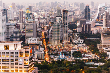 Fototapeta na wymiar Aerial view of Bangkok modern office buildings, condominium in Bangkok city downtown at the dusk. With city and traffic lights.