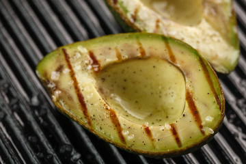 sliced fresh avocado on the grill. Health food. Barbeque avocado